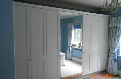 White fitted wardrobe and mirror